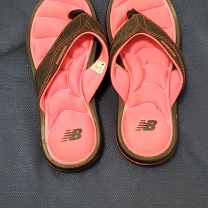 Pink and black flip flops